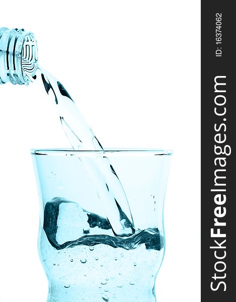 Water pouring into glass isolated on white