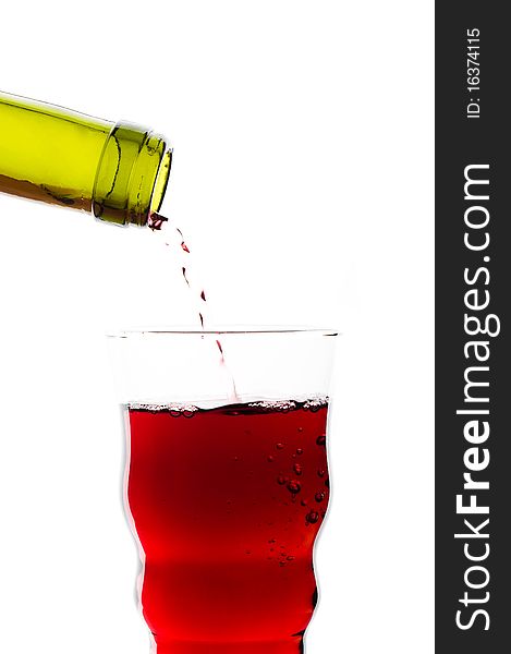 Red wine pouring into glass isolated on white