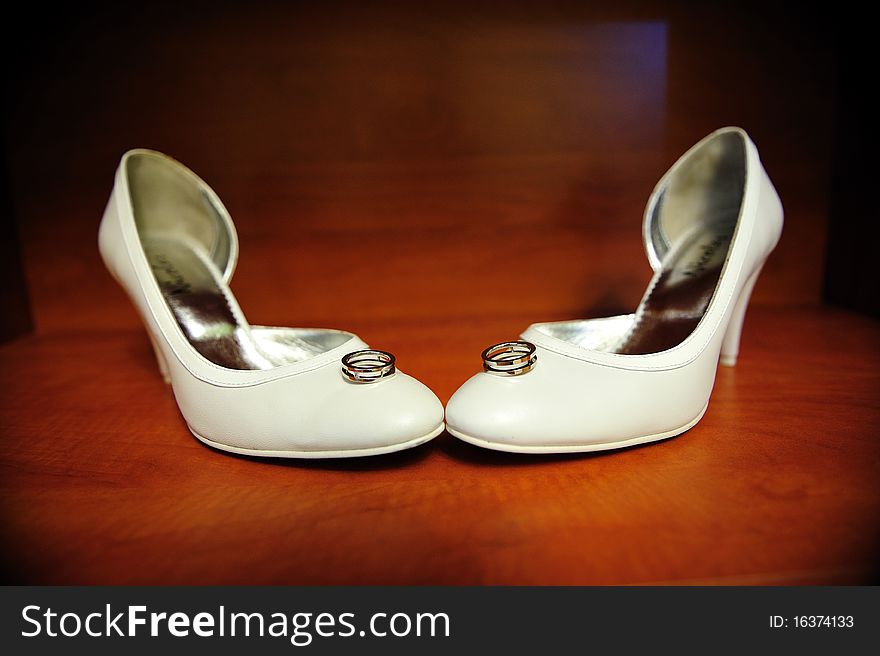 Wedding rings sitting on the bride shoes. Wedding rings sitting on the bride shoes