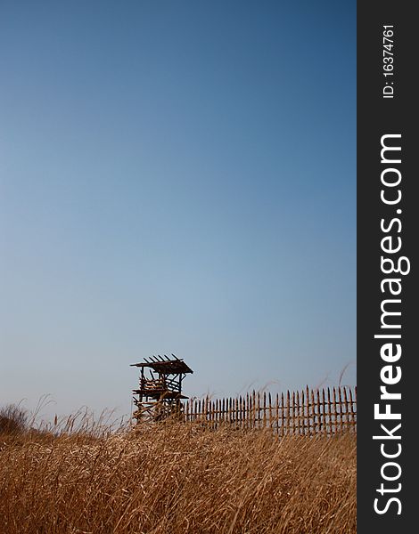 View of a wooden structure in a field of grass just outside of Yeoju, South Korea. View of a wooden structure in a field of grass just outside of Yeoju, South Korea.