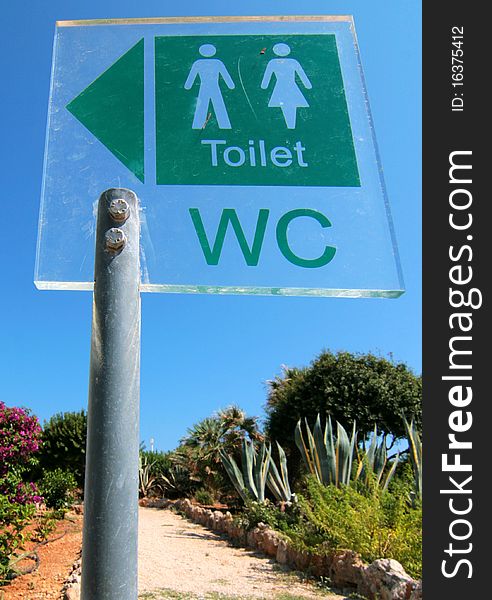 A toilet sign for ladies and gents toilets in flower garden