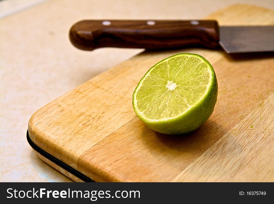 Half a lime on cutting board. Half a lime on cutting board