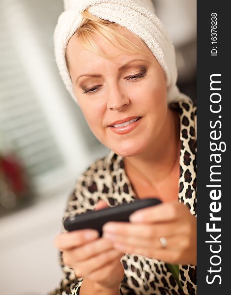 Attractive Woman Texting With Her Cell Phone with Narrow Depth of Field.