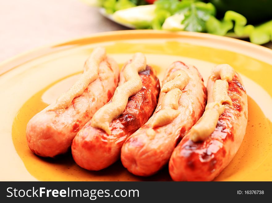 Appetizing grilled sausages on a plate. Appetizing grilled sausages on a plate.