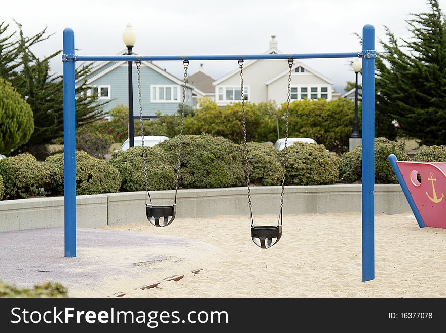 Swing on the children's playground on overcast day. Swing on the children's playground on overcast day