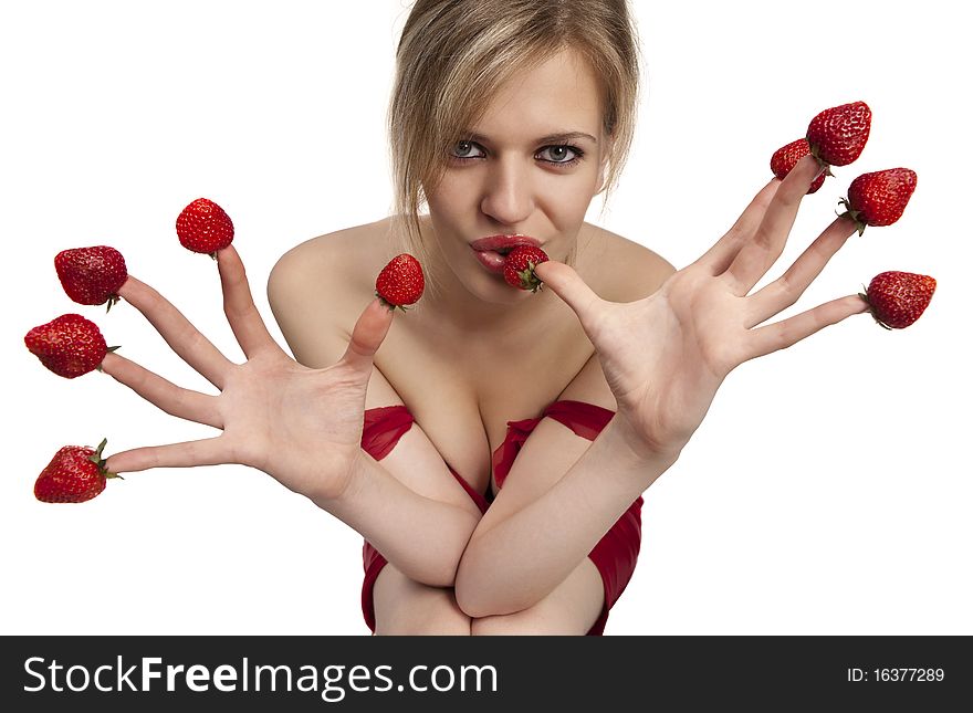 Woman with red strawberries picked on fingertips