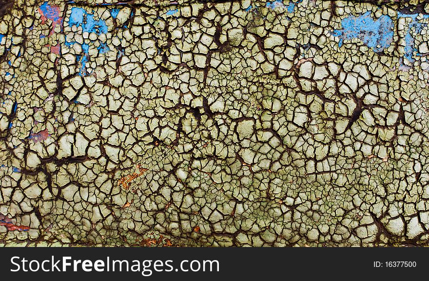 The texture of flaked green paint on wood sur