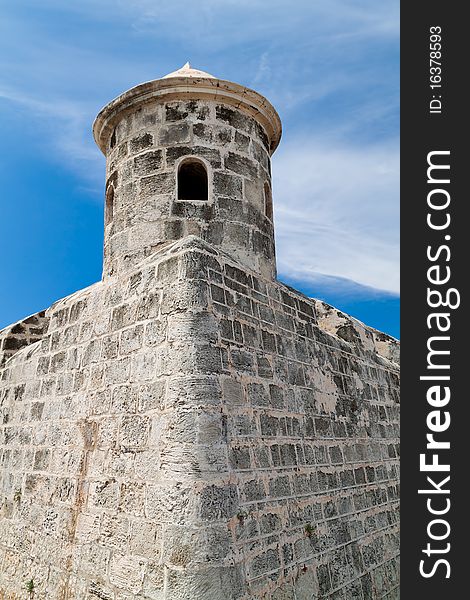 Tower and walls of an old castle with a beautiful blue sky background. Tower and walls of an old castle with a beautiful blue sky background