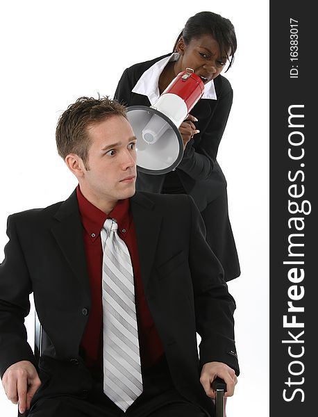 Attractive young business team over white background.  Woman yelling at man through megaphone.