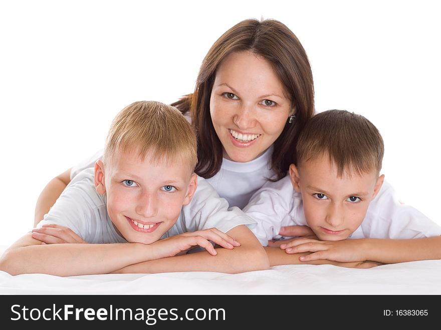 Smiling beautiful mom with  her sons sitting at the desk. Smiling beautiful mom with  her sons sitting at the desk