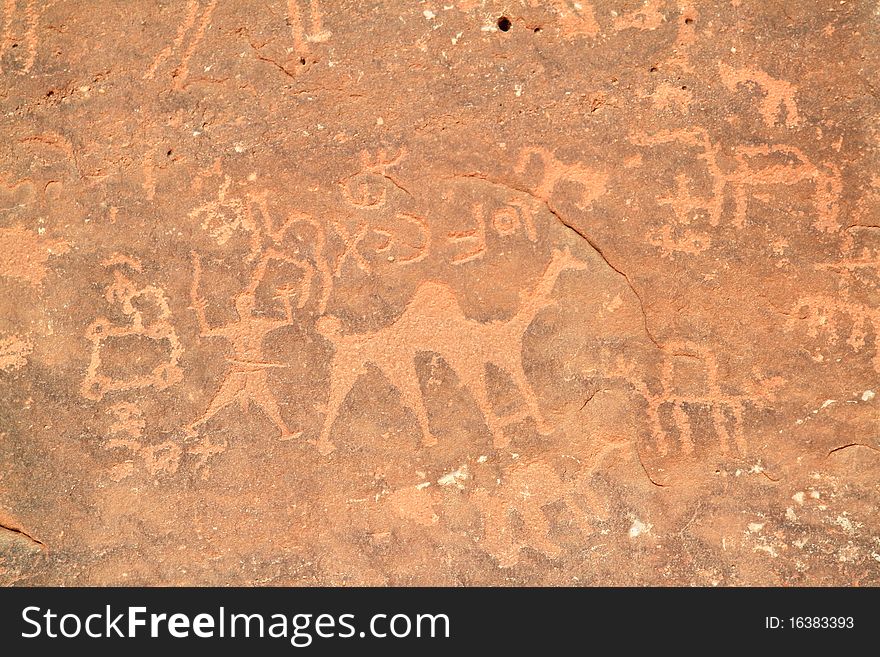 Images of people and camels carved into a rock wall at Wadi Rum, a UNESCO World Heritage site in Jordan.
