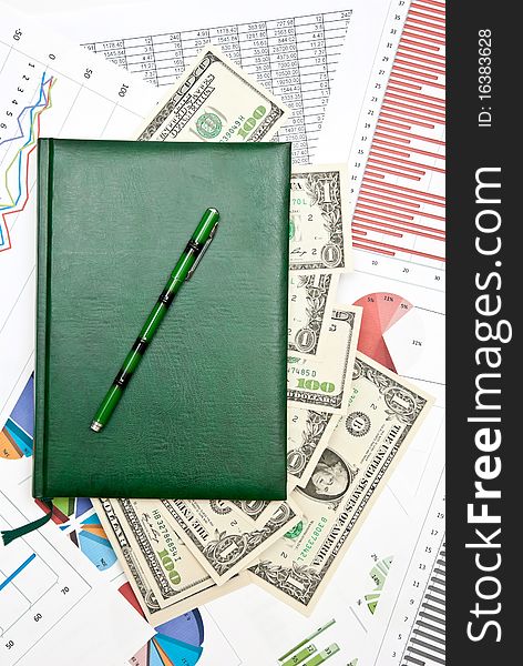 Notebook with money on business charts and diagrams. Notebook with money on business charts and diagrams
