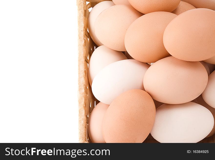 Eggs in wicker basket on white