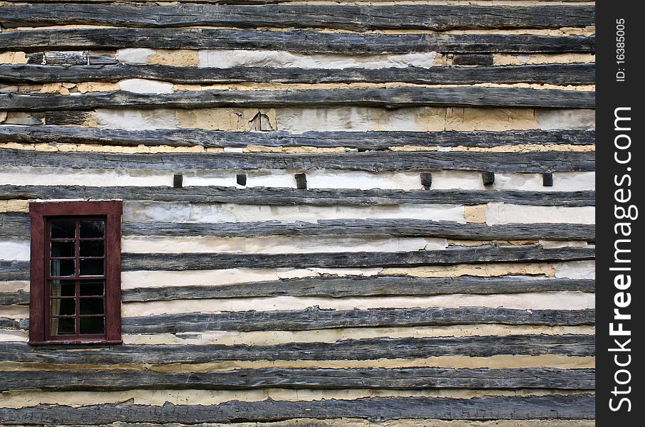 Single red window on the side of a log cabin. Single red window on the side of a log cabin