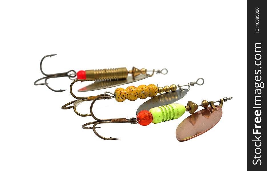 Metal angling baits on white background