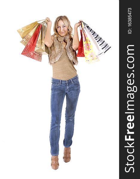 Sexy blond woman with shopping bags smiling happily