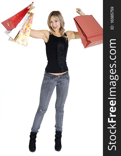 blond woman with shopping bags smiling happily. blond woman with shopping bags smiling happily