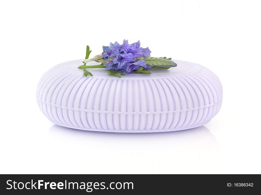 Lavender herb soap bar with flower and leaf sprig isolated over white background.