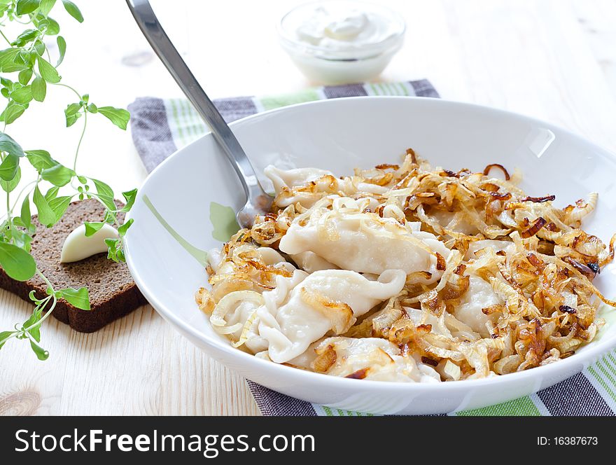 Plate of dumplings with rye bread,garlic and sour cream. Plate of dumplings with rye bread,garlic and sour cream