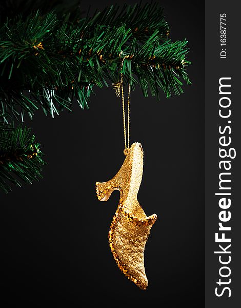 Gold shoe on the artificial Christmas tree