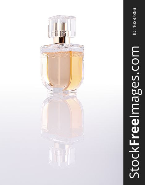 Back lit female perfume bottle with reflection with clipping path around the bottle and reflection. Back lit female perfume bottle with reflection with clipping path around the bottle and reflection.