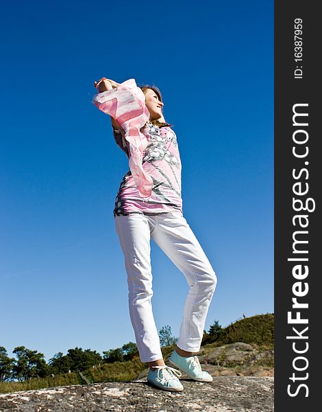 Beautiful young brunette plays with a handkerchief against the sky. Beautiful young brunette plays with a handkerchief against the sky