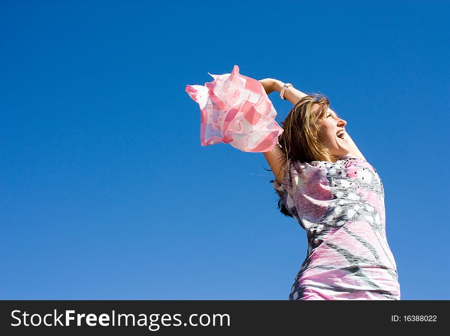 Positive young girl against the sky in summer