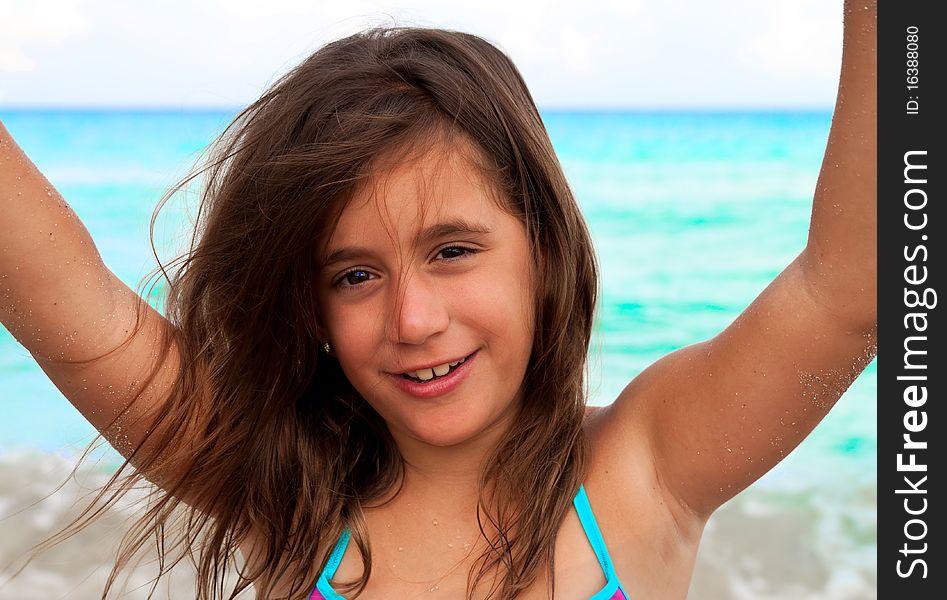 Beautiful Girl Raising Her Arms At A Beach