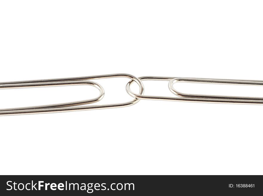 Two paperclips linked together, isolated. Two paperclips linked together, isolated.