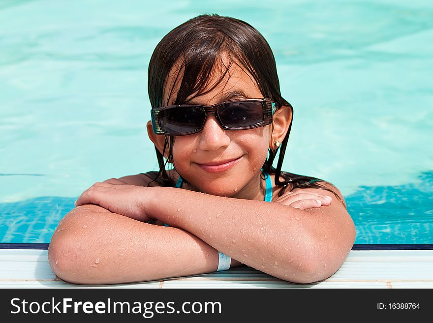 Girl Wearing Sunglasses  In A  Swimming Pool