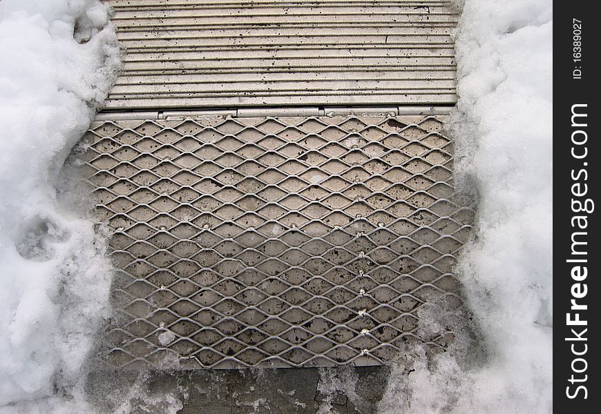 Mired metal skid board buried in ice. Mired metal skid board buried in ice