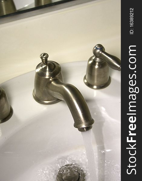 Chrome faucet with running water. Chrome faucet with running water