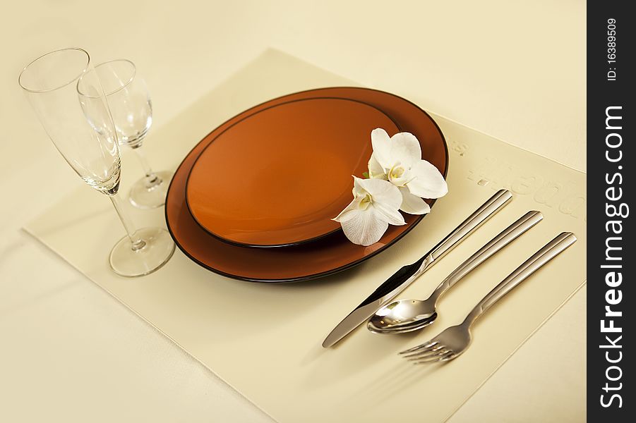 Plate on table with orchid flower