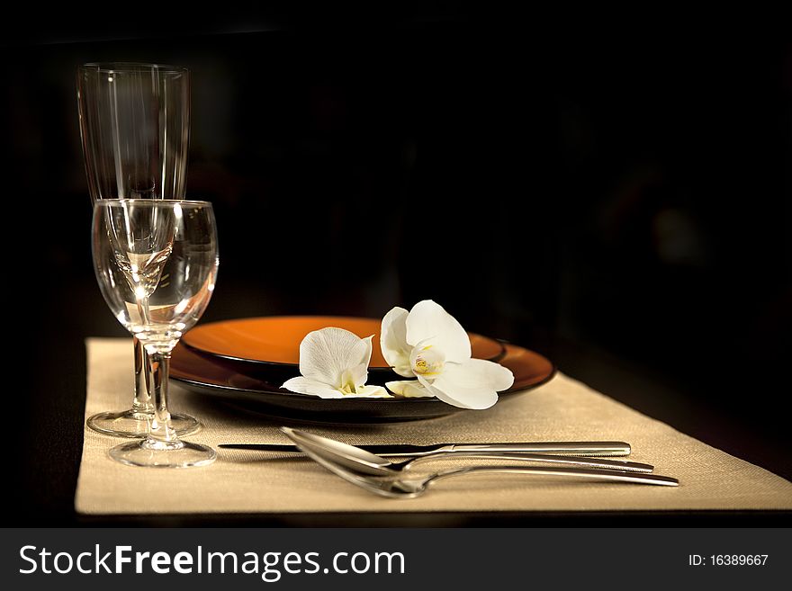 Plate on table with orchid flower