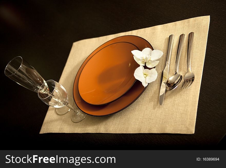 Plate on table with orchid flower
