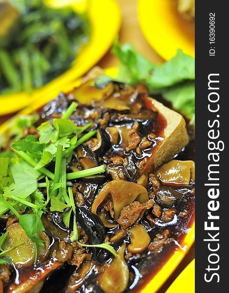 Chinese vegetarian cuisine cooked with bean curd and topped with healthy mushrooms. Chinese vegetarian cuisine cooked with bean curd and topped with healthy mushrooms.