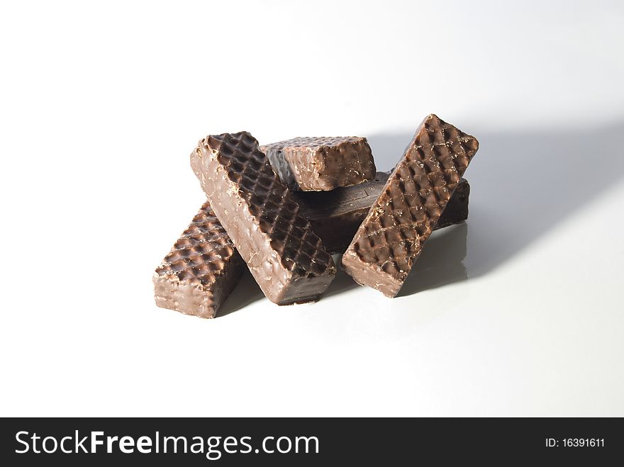 A stack of chocolate covered wafers on a white background. A stack of chocolate covered wafers on a white background