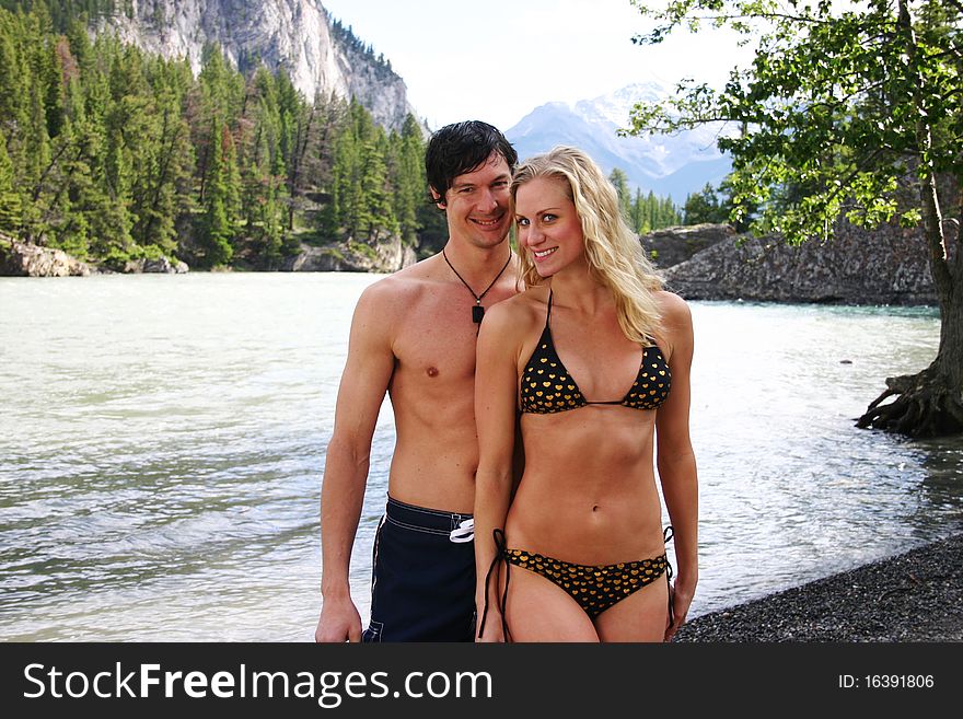 Couple in swim suits with mountains in background