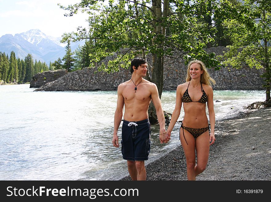 Couple walking on beach in swim suits