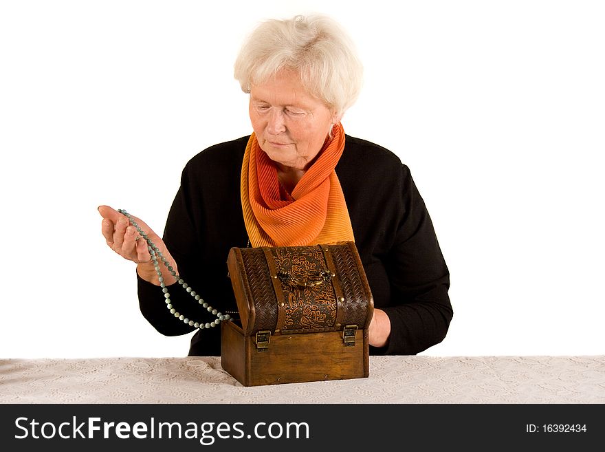Senior woman with jewelery in her hand. Senior woman with jewelery in her hand