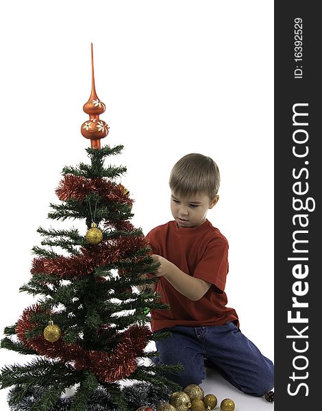 Small boy decorate a New Year tree