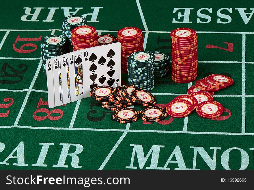 Casino card game showing chips on green cloth background. Casino card game showing chips on green cloth background