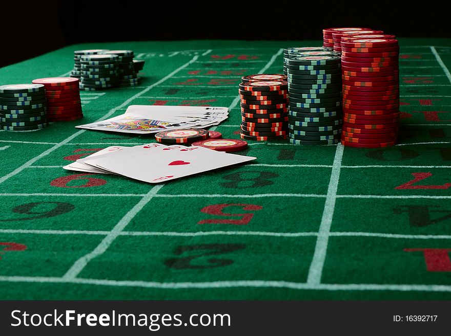 Casino card game showing chips on green cloth background. Casino card game showing chips on green cloth background