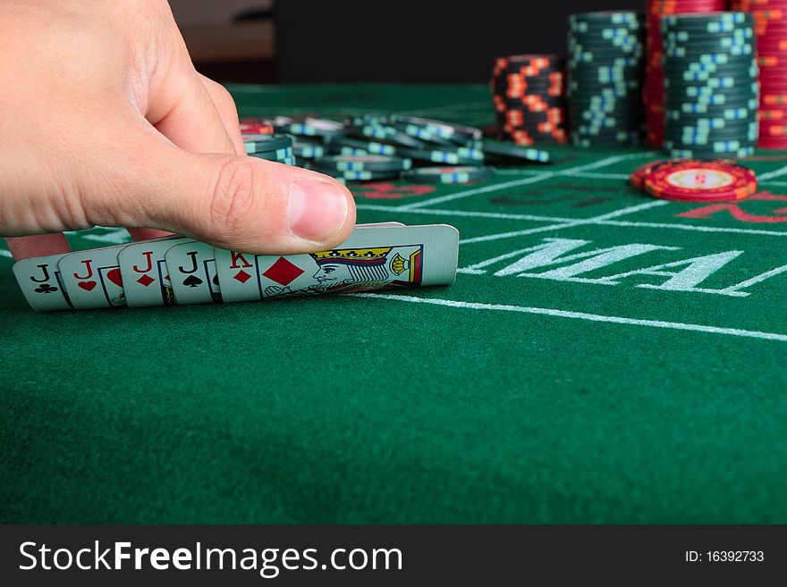 Casino card game showing chips on green cloth background. Casino card game showing chips on green cloth background