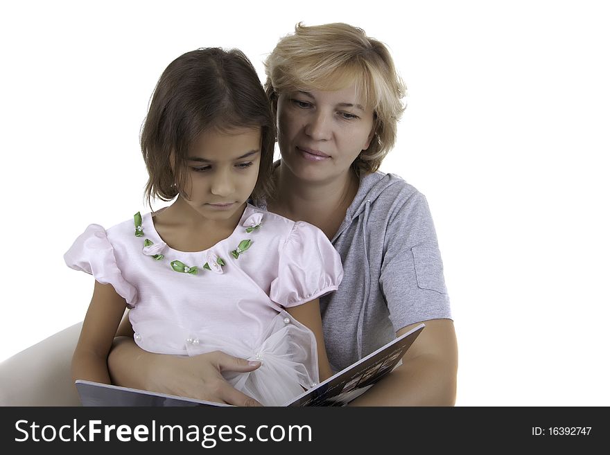 Mother reads to the daughter the book, isolated