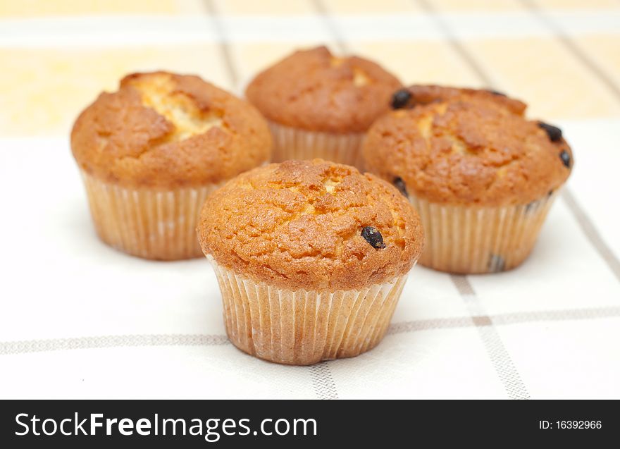 Plum cakes on checked tablecloth