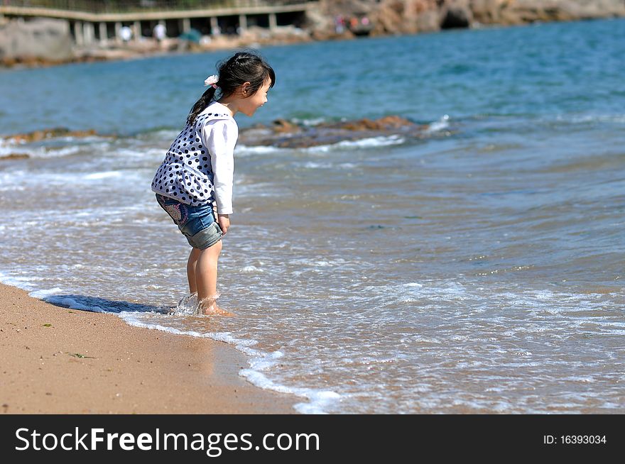 A Lovely Chinese girlï¼Œwho is playing on the beach