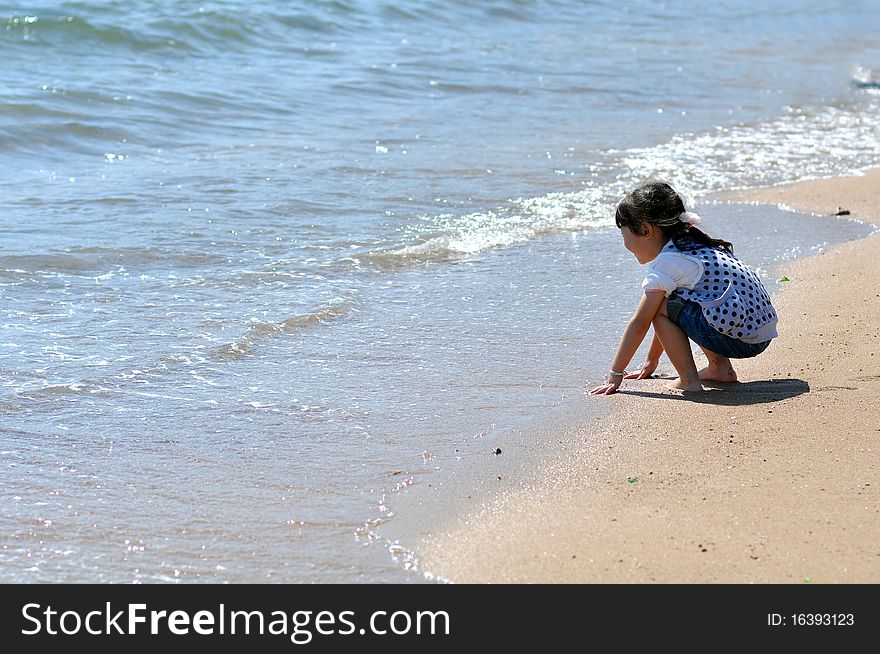 A Lovely Chinese girl，who is playing on the beach
