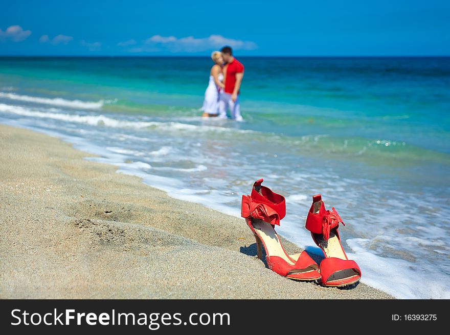 Young Attractive Couple At The Beach Kissing