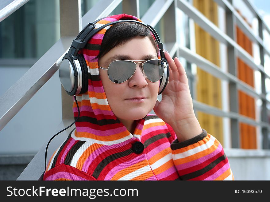 Attractive woman enjoying music outdoors. Attractive woman enjoying music outdoors